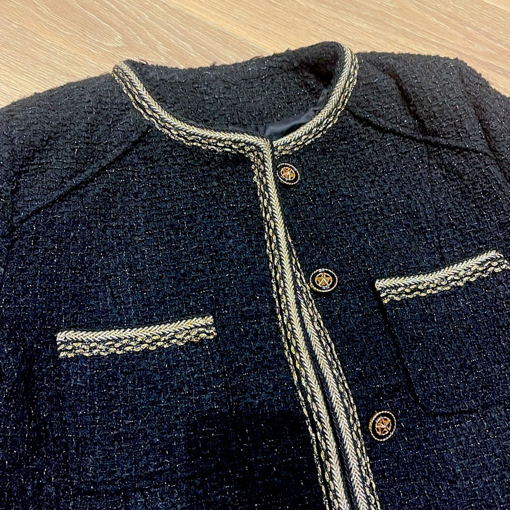 Black Chanel style jacket with gold trim